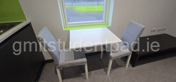 Collapsible dining table with two chairs. Chairs can be stored in the bedroom at the desk and one behind the couch.